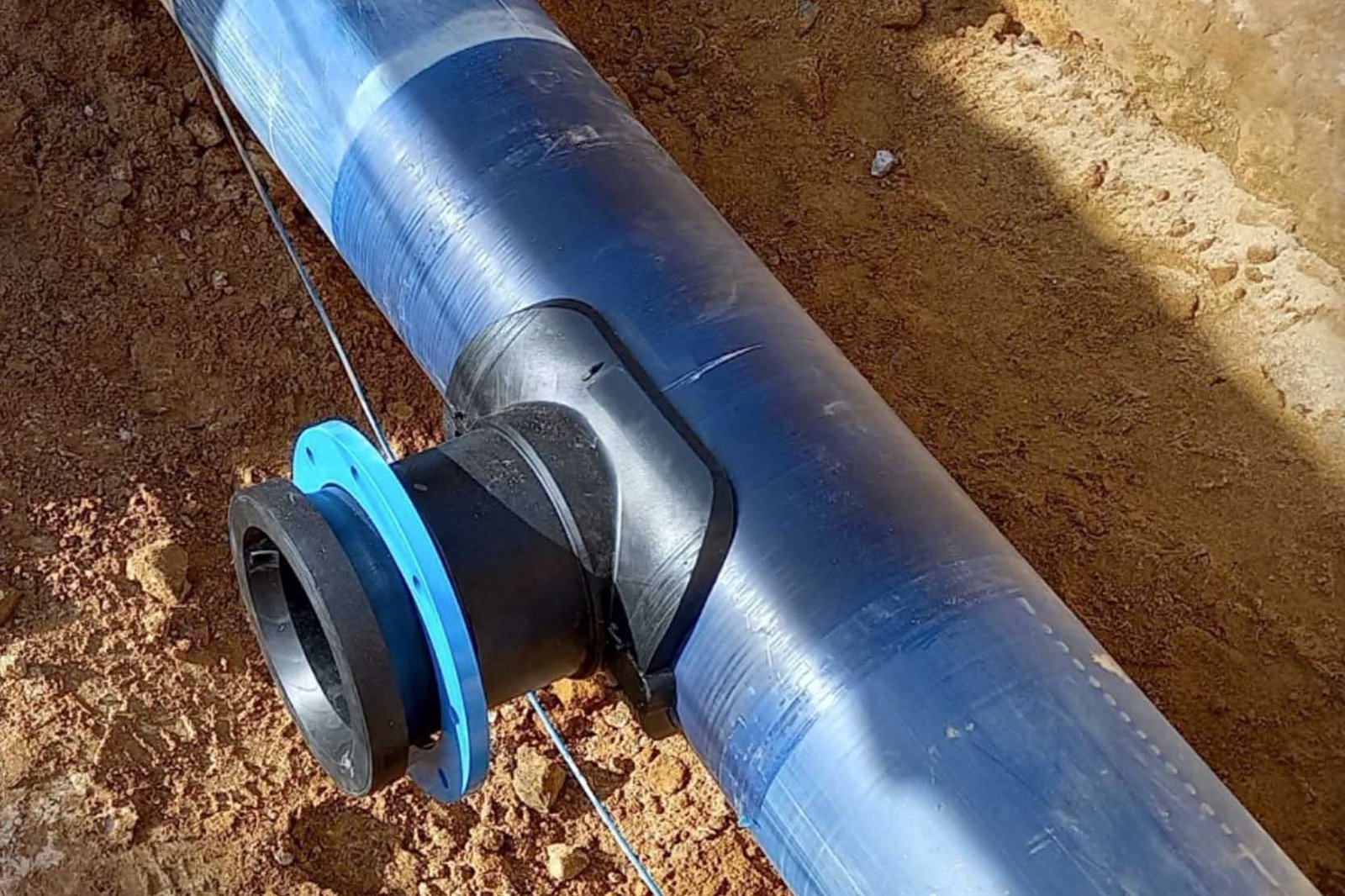 Close-up of an electrofusion saddle on an HDPE pipe