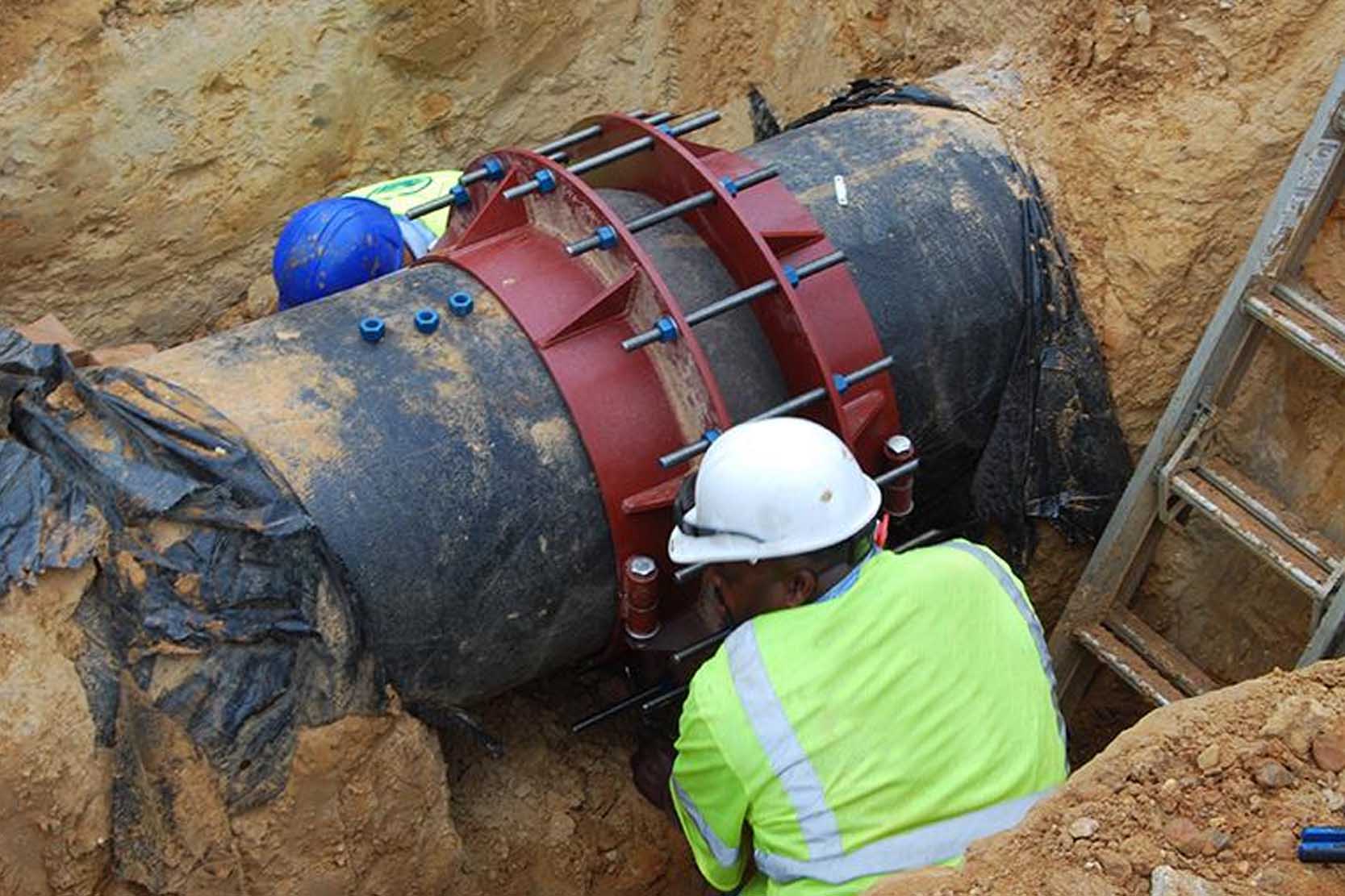 A specialized bell joint repair clamp sealing a leaking DI pipe joint