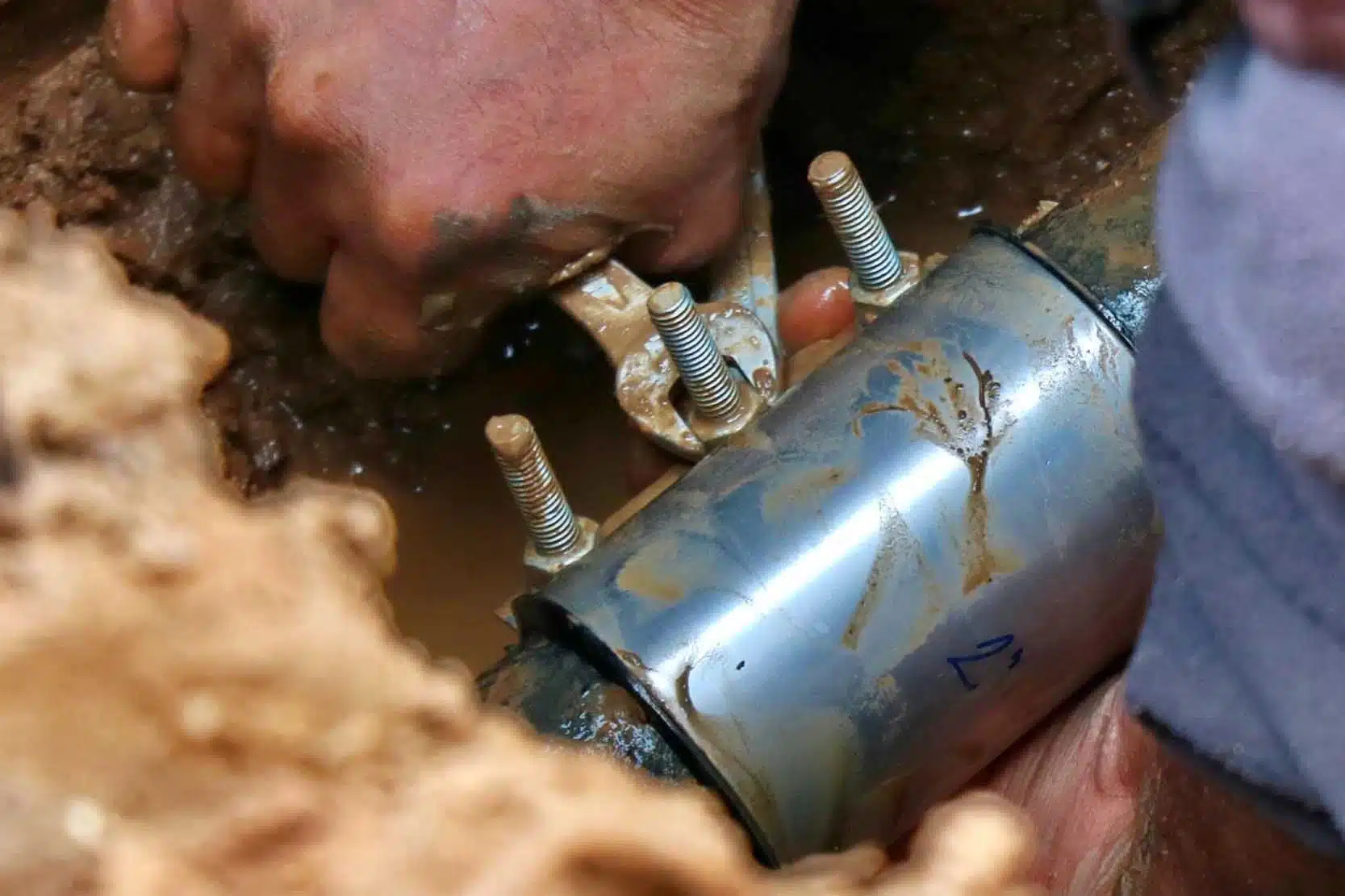 Photo showing a poorly installed, leaking repair clamp as an example of failure