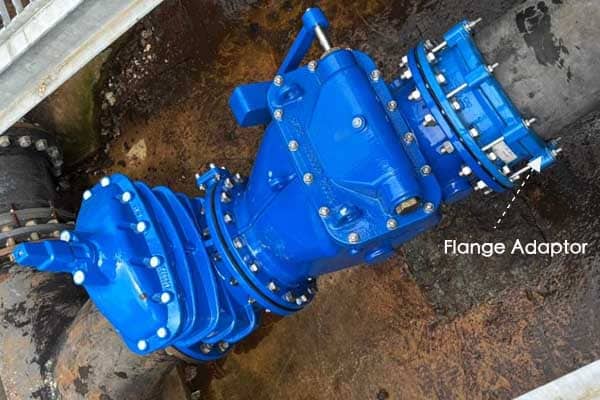A ductile iron flange adaptor connecting a blue pipe to a valve