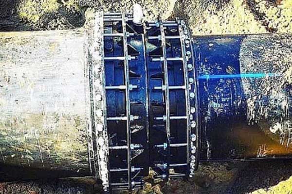 A collection of different pipe materials (PVC, DI, Steel) being joined by couplings