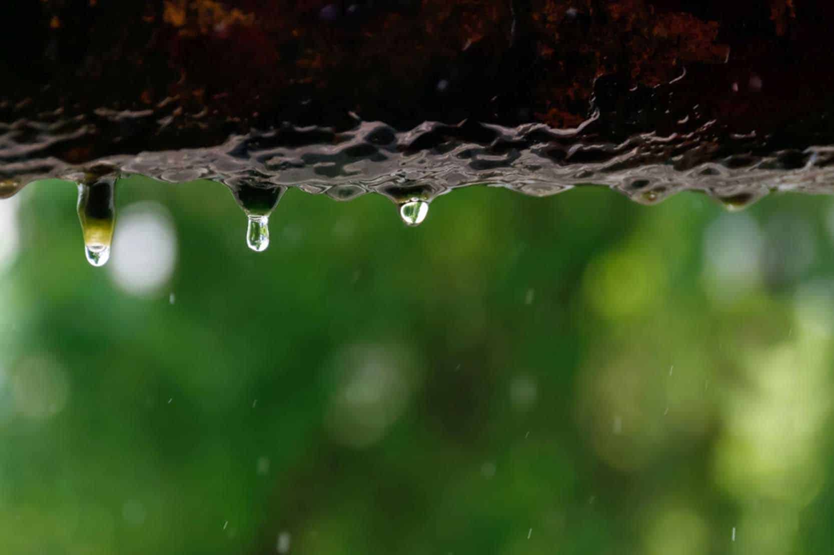 Water dripping from a small pinhole leak in a pipe