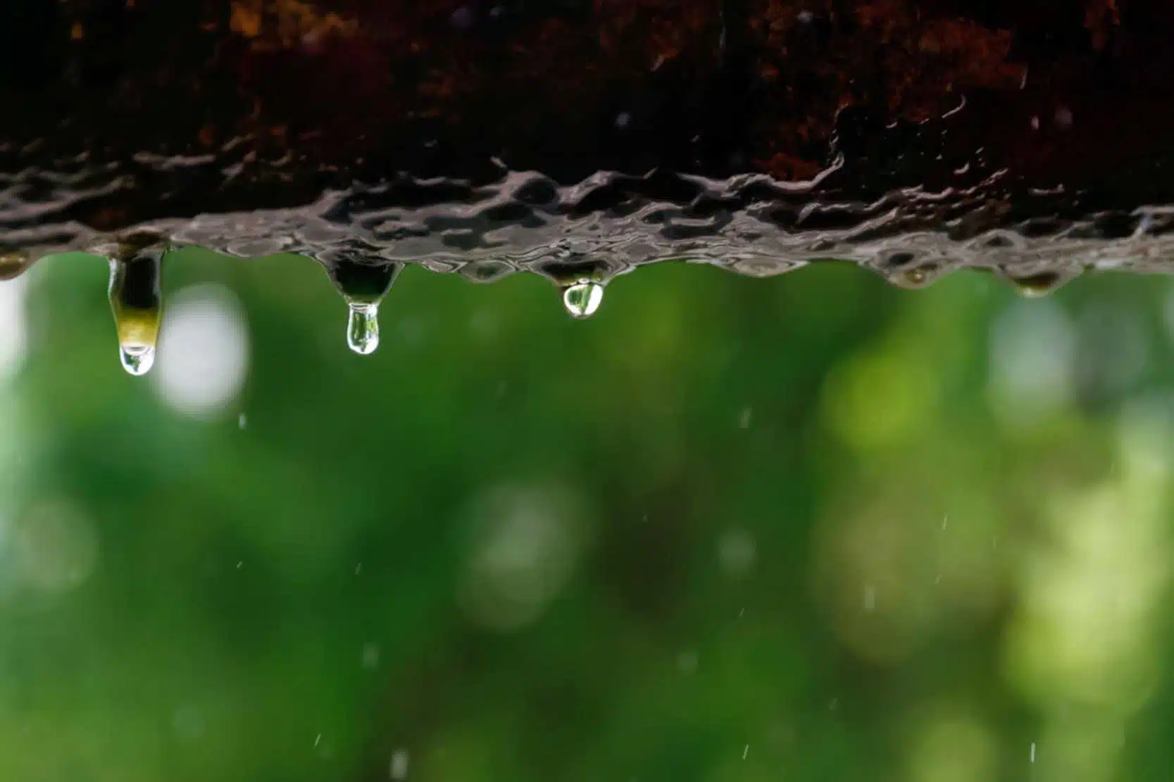 Water dripping from a small pinhole leak in a pipe